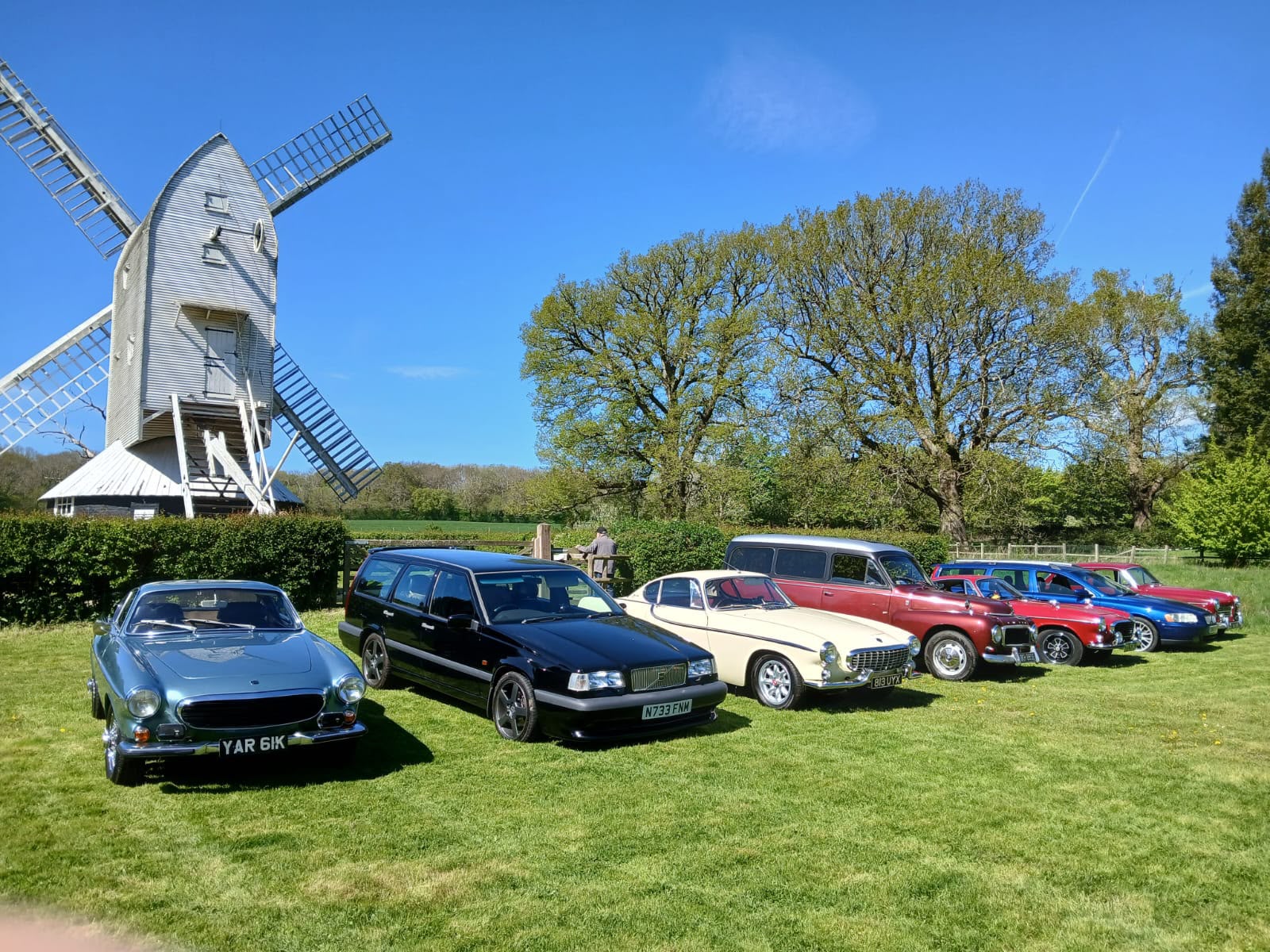 several volvos parked in front of the mill